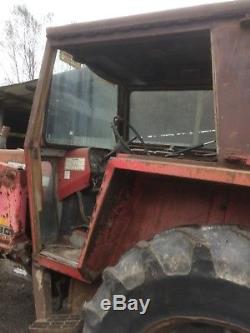 Massey Ferguson 575 with loader bucket and counterweight and PTO transmission